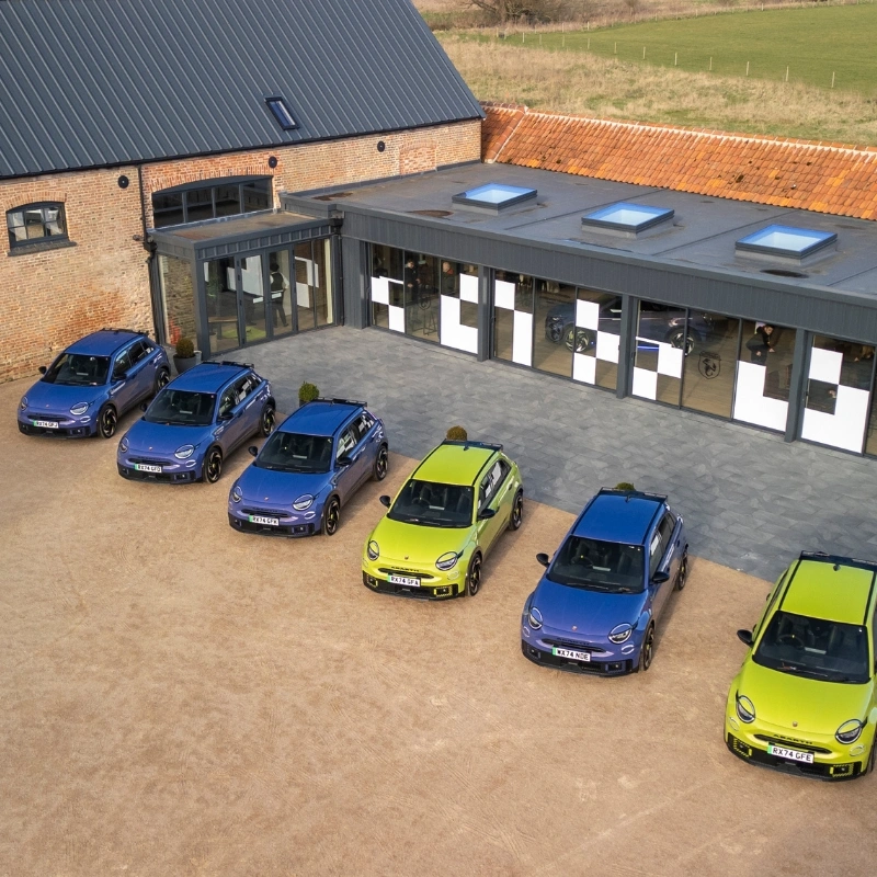 Six Abarth cars in enclosed courtyard