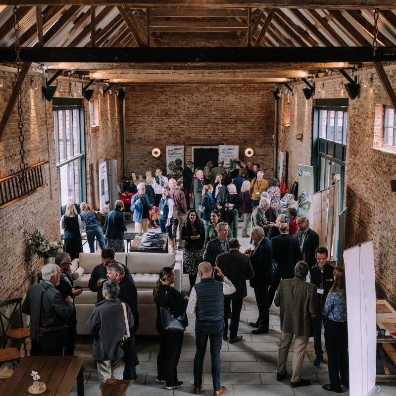 Guests chatting at a networking event in Thetford Farm Barn