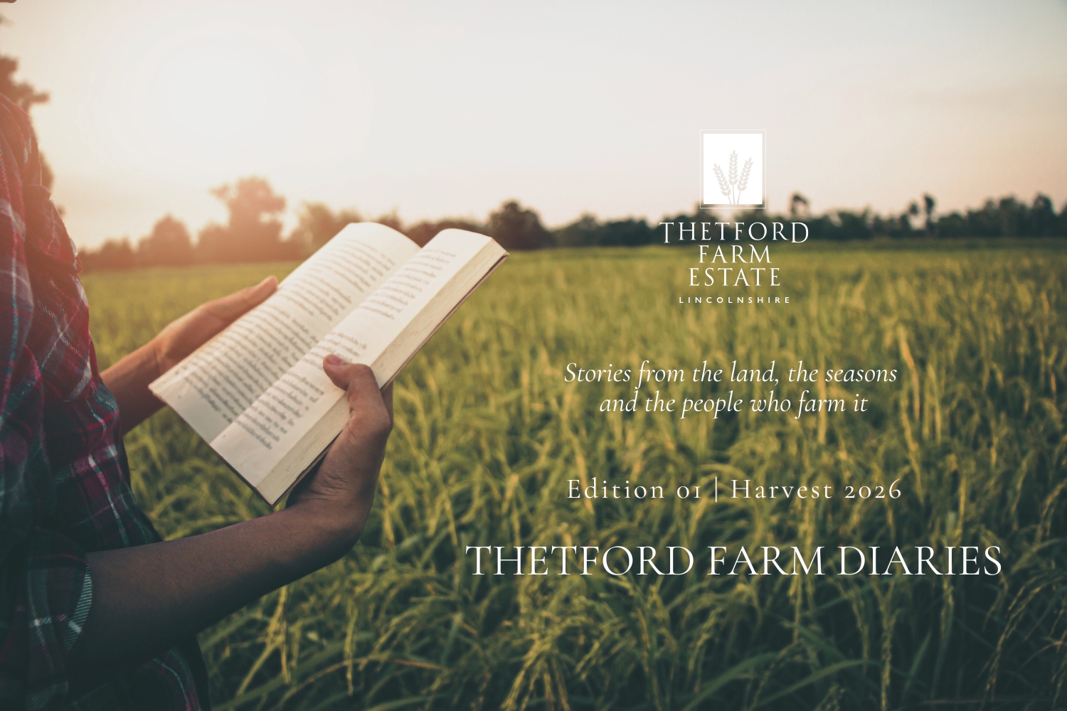 A farmer holding a book in a field